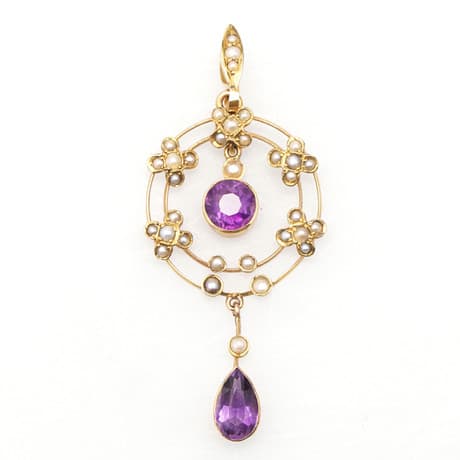 AN EDWARDIAN 9 CARAT GOLD AMETHYST AND SEED PEARL OPENWORK PENDANT.